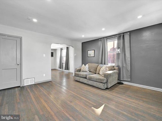 unfurnished living room featuring dark wood-type flooring