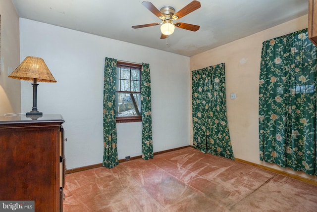 spare room featuring ceiling fan and light carpet