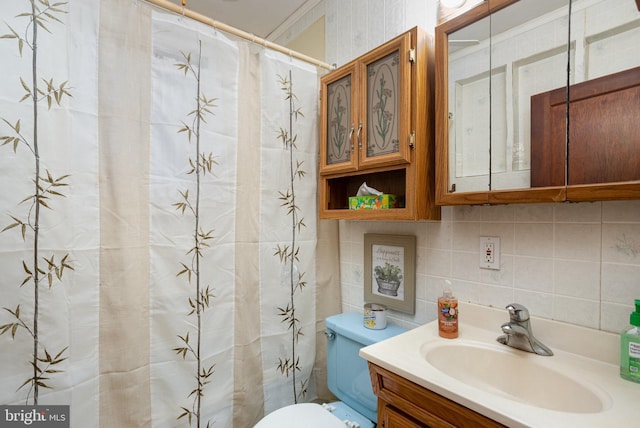 bathroom featuring tasteful backsplash, vanity, and toilet