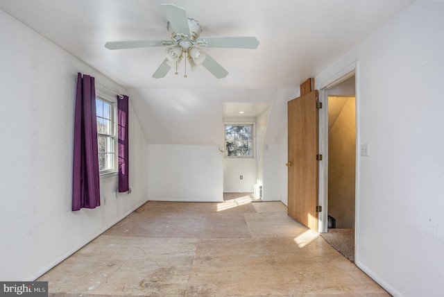 bonus room featuring lofted ceiling, ceiling fan, and a healthy amount of sunlight