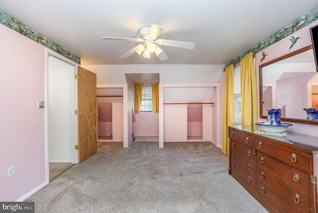 bedroom with light carpet, ceiling fan, and a closet