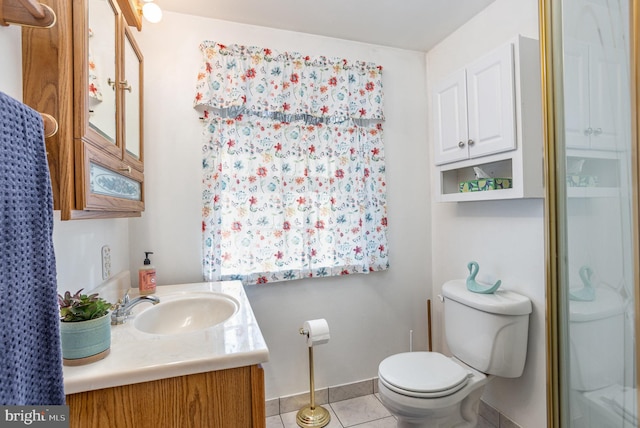 bathroom with vanity, tile patterned floors, toilet, and walk in shower