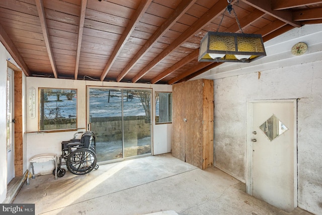 misc room with vaulted ceiling with beams, wood ceiling, and concrete flooring