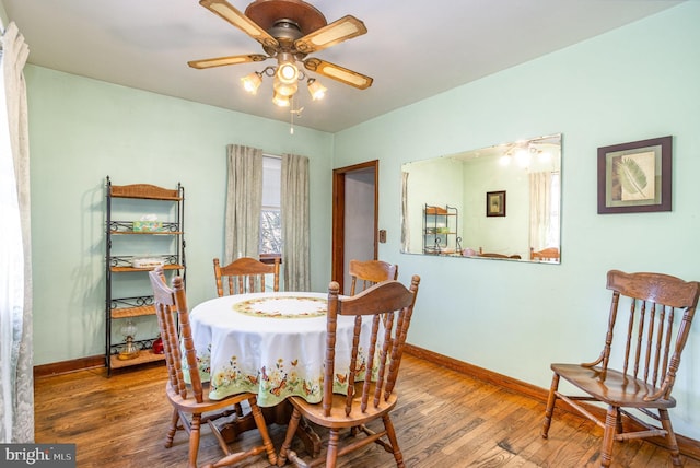 dining area featuring hardwood / wood-style flooring and ceiling fan