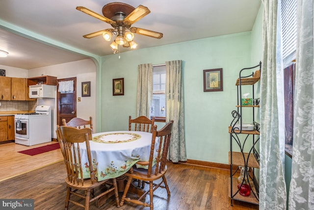 dining space with ceiling fan and hardwood / wood-style floors