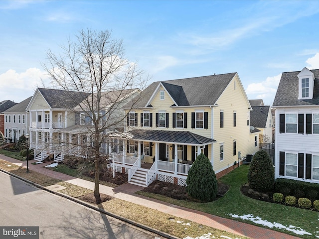 view of front of home featuring a porch, a front yard, and central air condition unit