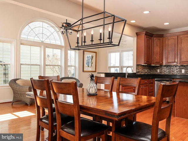 dining area featuring sink and light hardwood / wood-style flooring