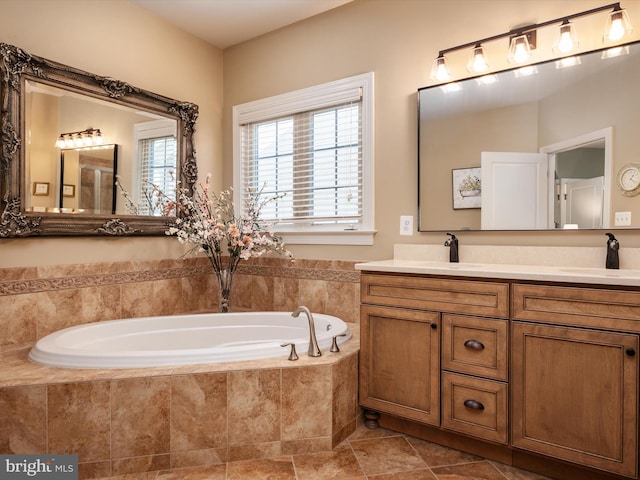 bathroom with vanity and tiled bath