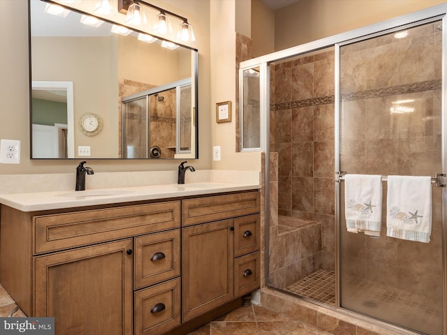 bathroom with an enclosed shower, vanity, and tile patterned floors