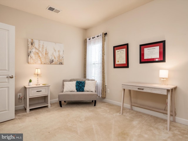 living area featuring light colored carpet