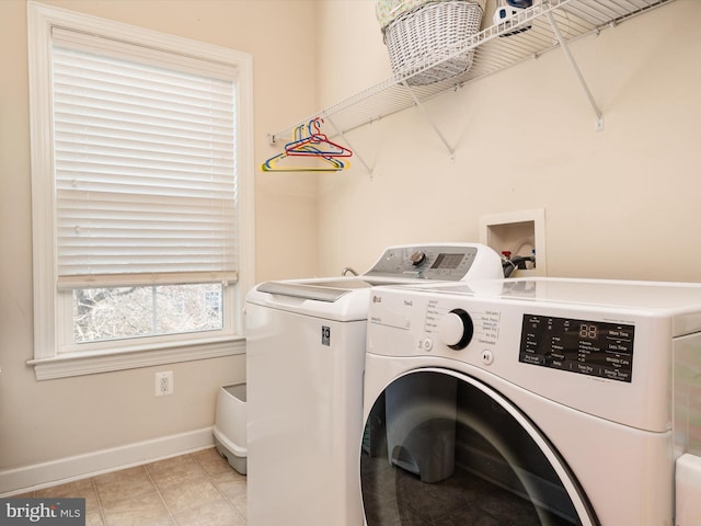 laundry room featuring light tile patterned floors and washing machine and clothes dryer