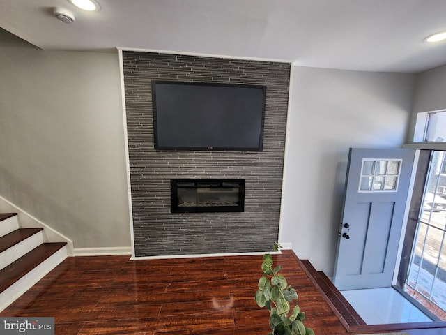 foyer featuring dark hardwood / wood-style flooring and a fireplace