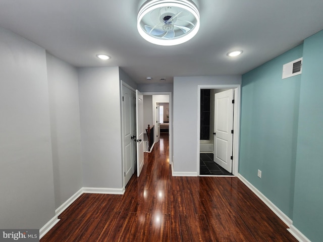 corridor with dark hardwood / wood-style flooring