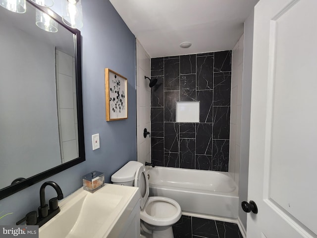 full bathroom featuring toilet, tiled shower / bath combo, tile patterned floors, and vanity