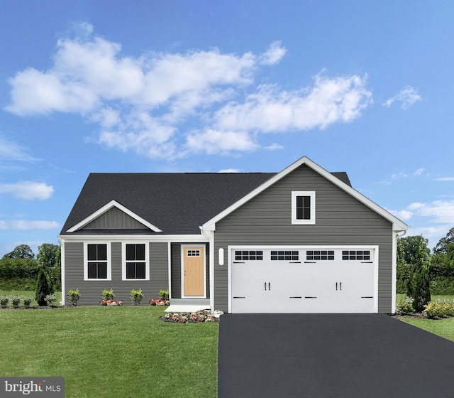 view of front of home with a garage and a front yard