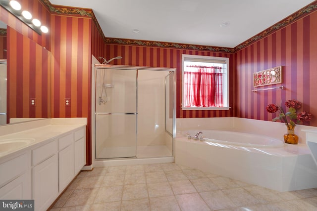 bathroom with wallpapered walls, a garden tub, and a stall shower