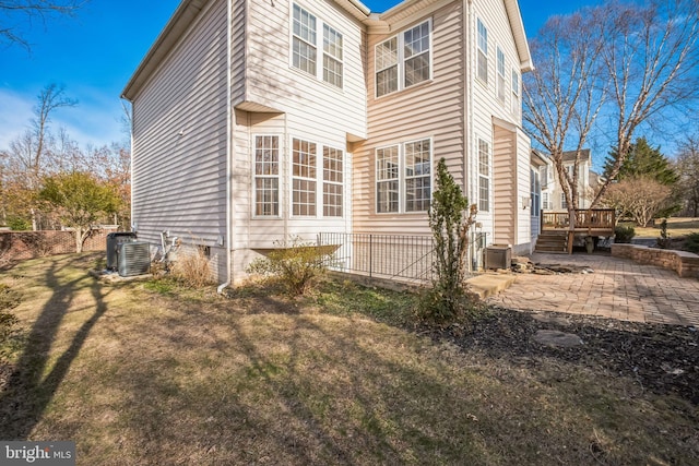 view of home's exterior with a yard, cooling unit, a patio, and a deck