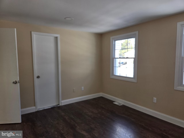 empty room with dark hardwood / wood-style floors