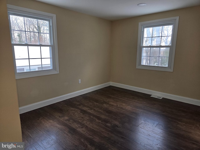 unfurnished room featuring dark hardwood / wood-style floors