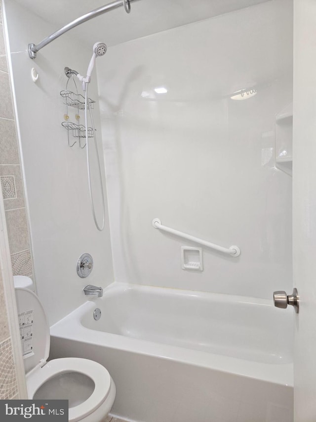 bathroom featuring bathtub / shower combination and toilet