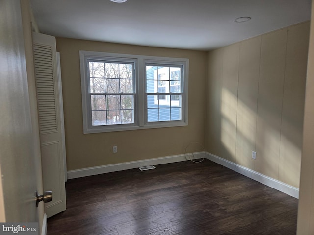 empty room with dark wood-type flooring