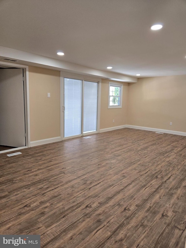 basement with dark hardwood / wood-style floors