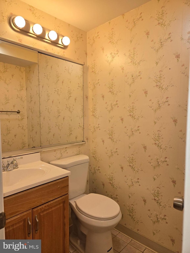 bathroom featuring vanity, tile patterned floors, and toilet