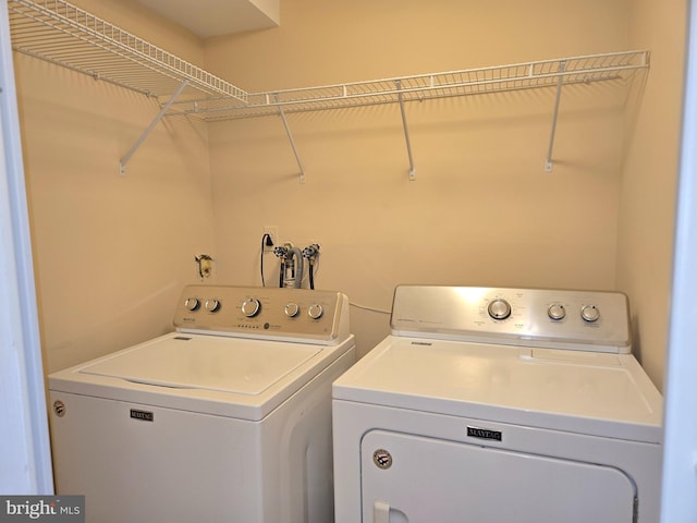 clothes washing area with washing machine and dryer