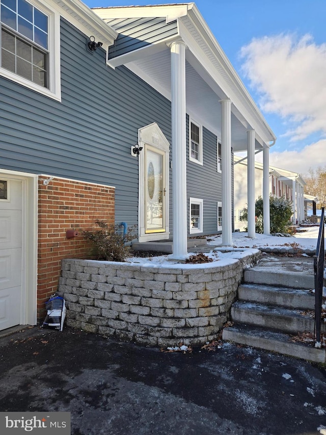 doorway to property featuring covered porch