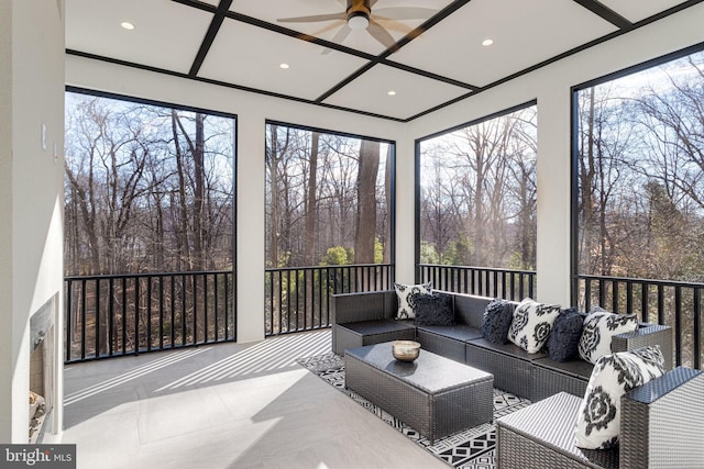 sunroom / solarium featuring coffered ceiling and a ceiling fan