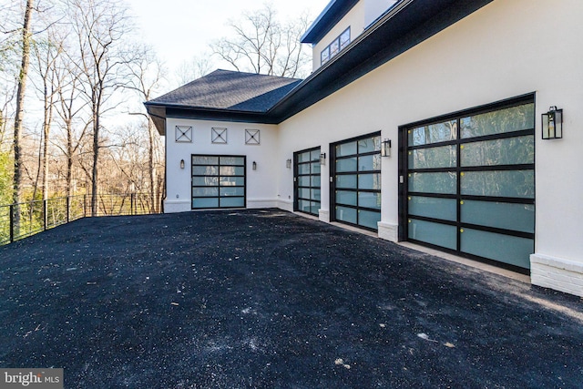 exterior space featuring driveway and fence