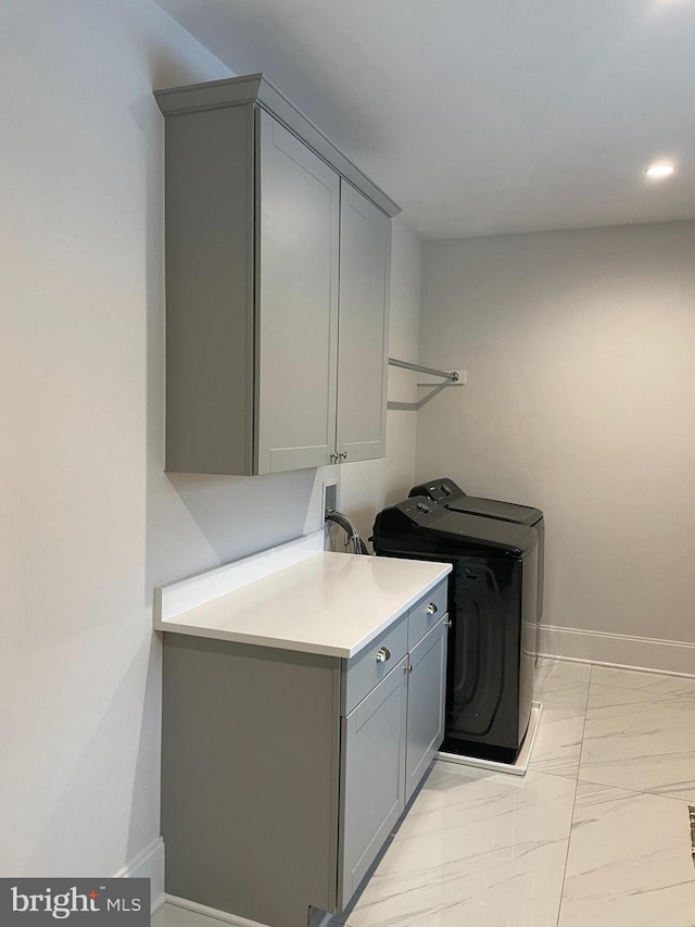 clothes washing area featuring baseboards, recessed lighting, cabinet space, independent washer and dryer, and marble finish floor