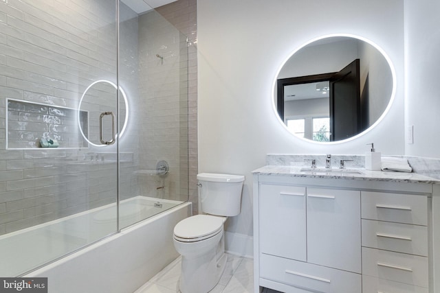 full bathroom featuring baseboards, enclosed tub / shower combo, toilet, and vanity