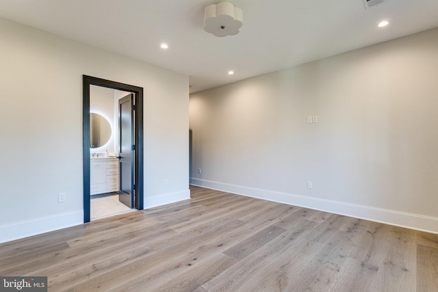 empty room featuring recessed lighting, visible vents, baseboards, and light wood-style floors