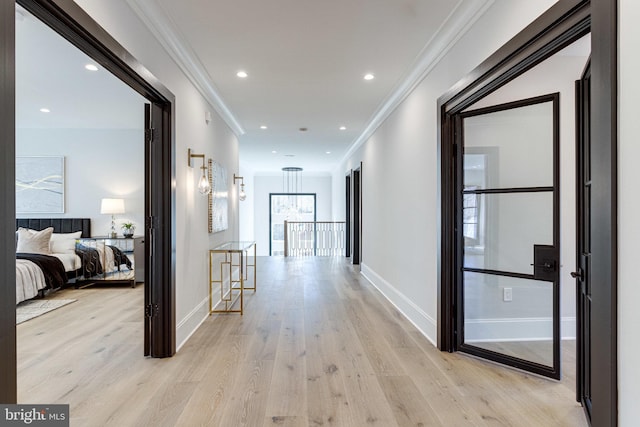 hall with crown molding, baseboards, an upstairs landing, recessed lighting, and light wood-style floors