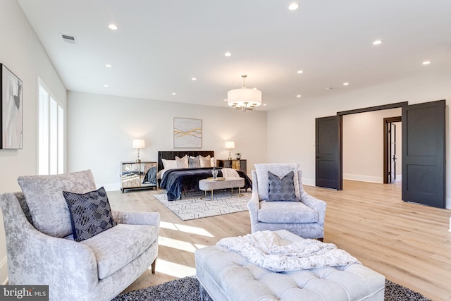 bedroom featuring visible vents, baseboards, recessed lighting, a notable chandelier, and light wood-type flooring