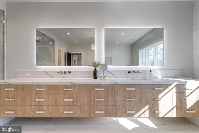 bathroom featuring a sink, marble finish floor, recessed lighting, and double vanity