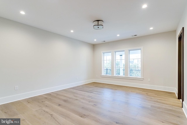 unfurnished room with recessed lighting, baseboards, and light wood-style flooring