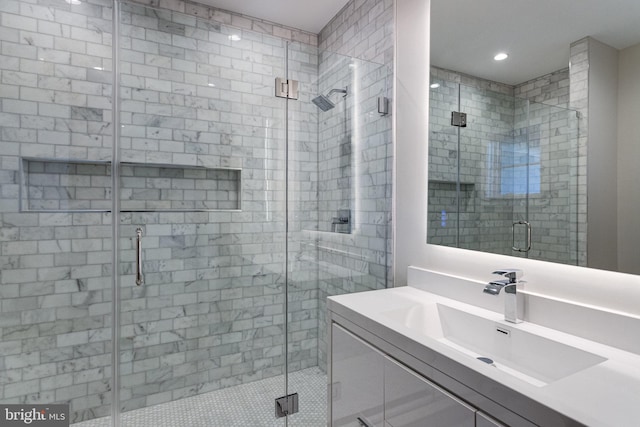 bathroom featuring vanity and a shower stall