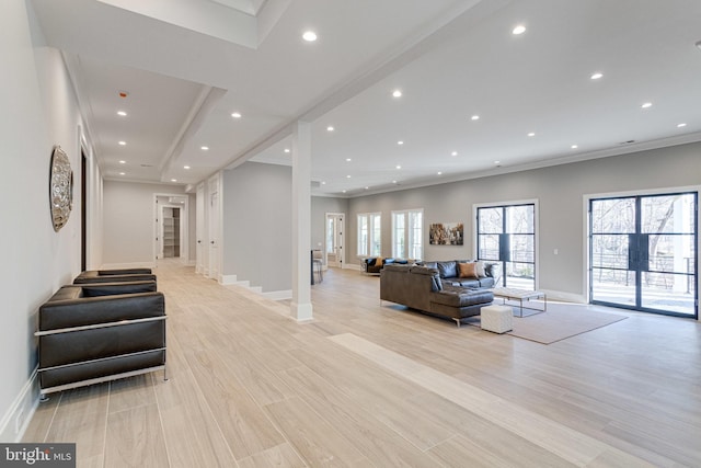 interior space with recessed lighting, light wood-type flooring, baseboards, and crown molding