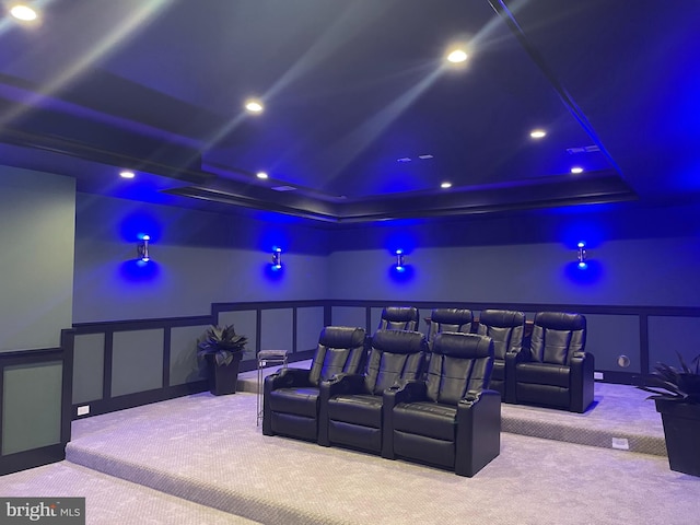 cinema room with carpet, a wainscoted wall, recessed lighting, a decorative wall, and a raised ceiling