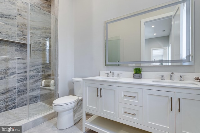 full bath featuring double vanity, a shower stall, toilet, and a sink