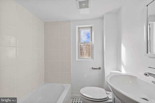 bathroom featuring toilet, sink, and a tub