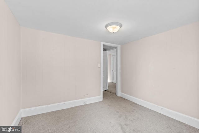 empty room featuring light carpet