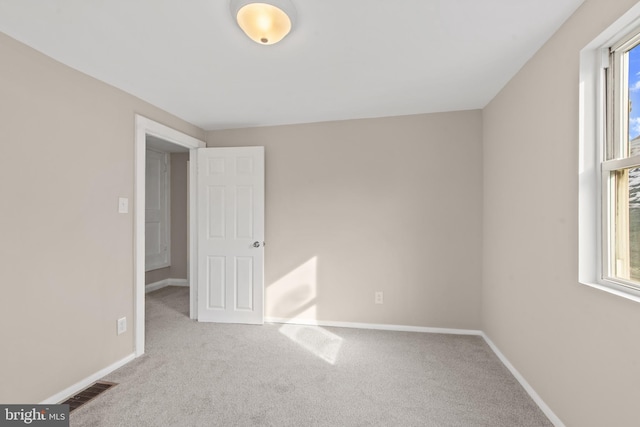 unfurnished bedroom with light colored carpet