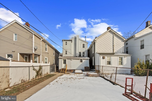 rear view of house featuring central AC