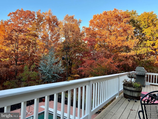 wooden deck featuring a grill