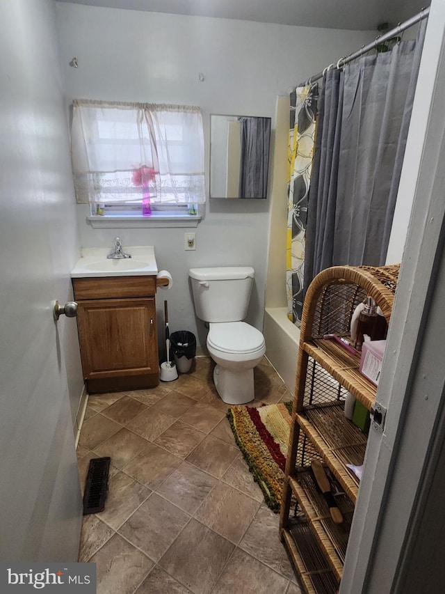 full bathroom with toilet, vanity, and shower / bath combination with curtain