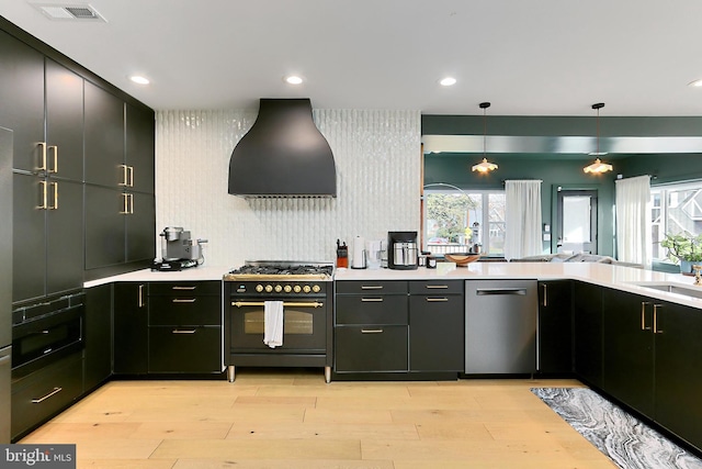 kitchen with pendant lighting, double oven range, ventilation hood, stainless steel dishwasher, and light wood-type flooring