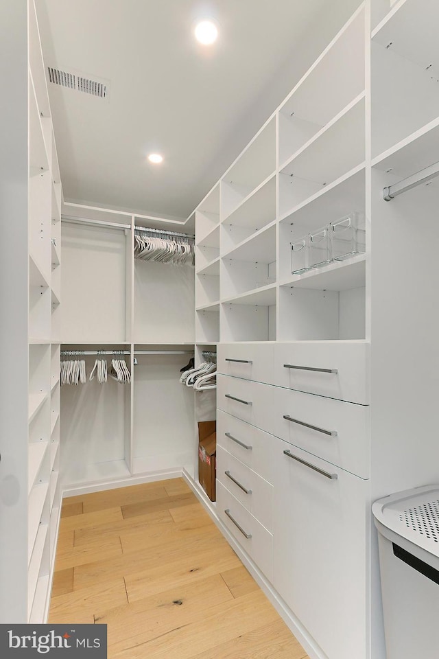 spacious closet featuring hardwood / wood-style floors